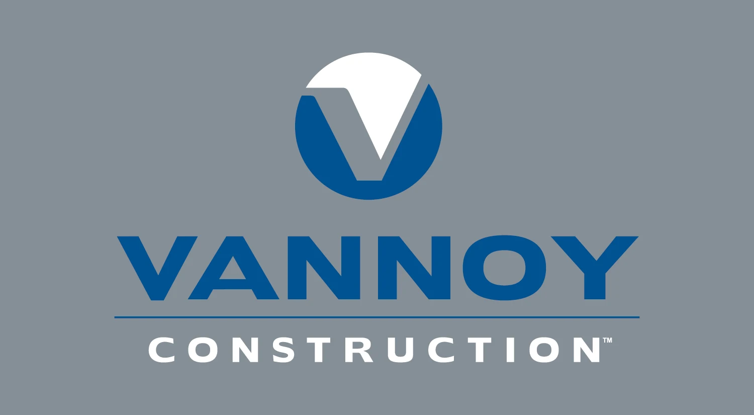 Vannoy Logos_Grey BG Vannoy Construction logo with a stylized “V” in a blue circle above the company name on a gray background.